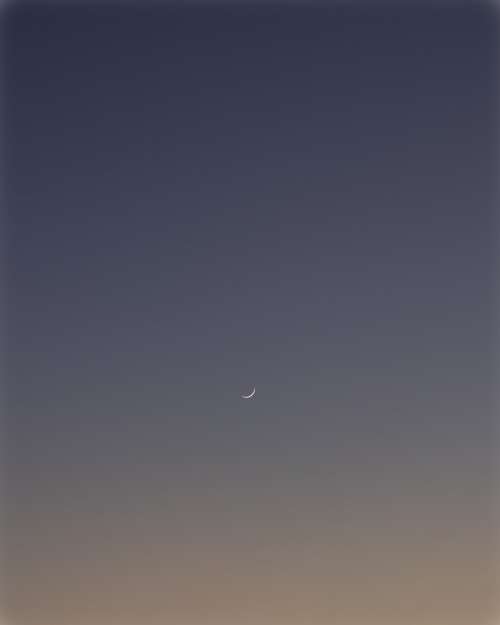 Thin Crescent Moon In The Dark Blue Sky Photo