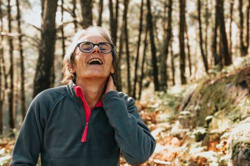 Woman Laughs While Outdoors In A Forest Photo