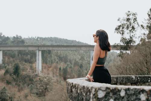Woman Stands In At Stone Lookout And Take In The Forest View Photo