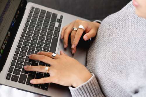 Hands With Gold Rings Type On A Laptop Photo