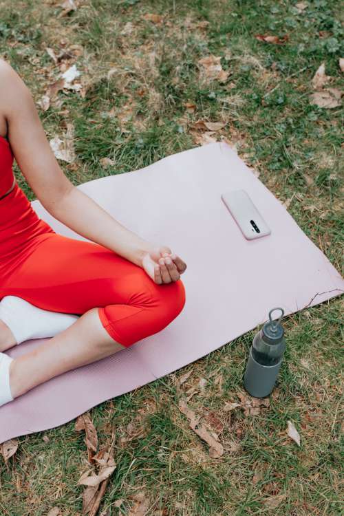 Persons Legs Sitting On A Pink Yoga Mat Outdoors Photo