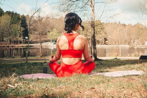 Woman Sits Outdoors On A Pink Yoga Mat Photo