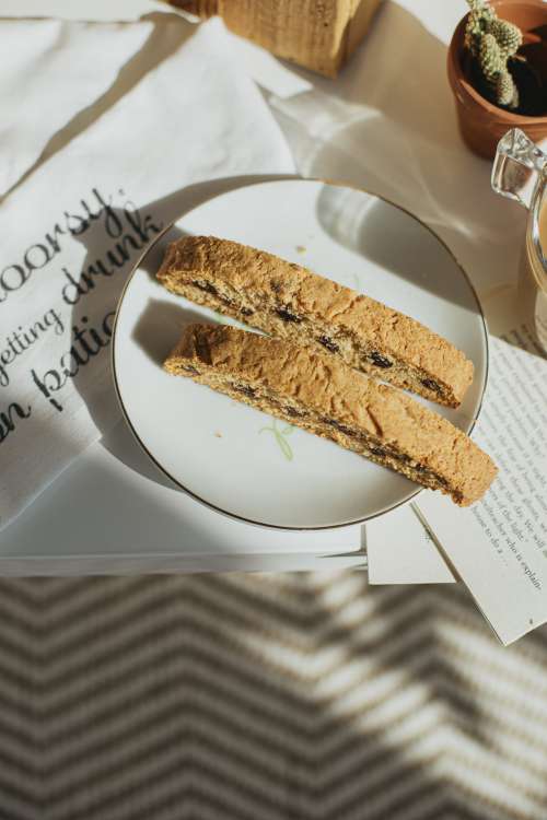 Flatlay Of A White Plate With Fresh Biscotti On A Table Photo