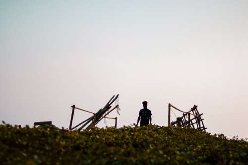 Standing With Parts Of A Wooden Structure Around Them Photo