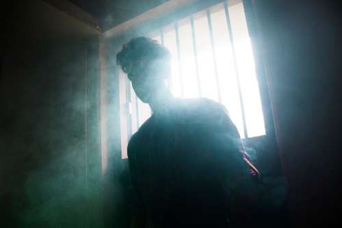 Person Silhouetted By A Window In A Smoky Room Photo