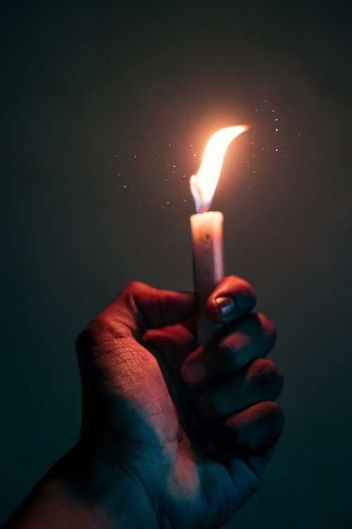 Hand Holds A Lite Candle Photo