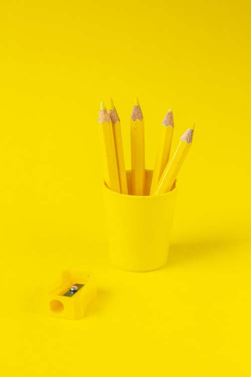 Yellow Pencils Cup And Sharper On Yellow Background Photo