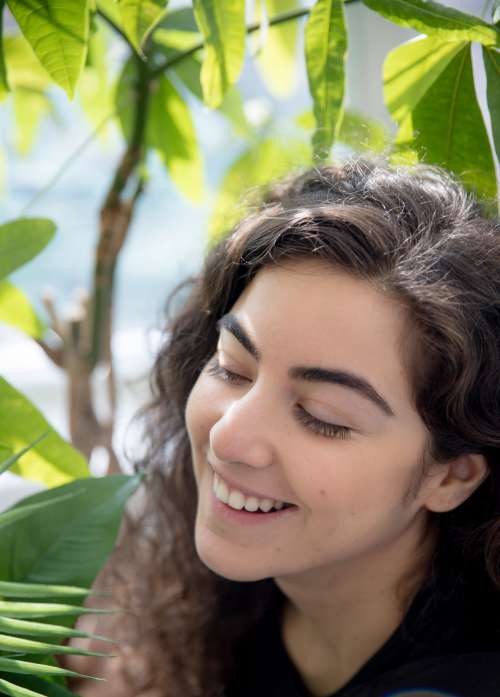 Person Smiling While Looking At Plants Photo