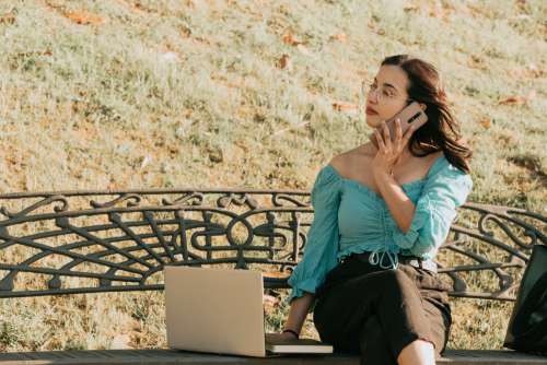 Woman Working Outdoors Holds A Phone To Her Ear Photo