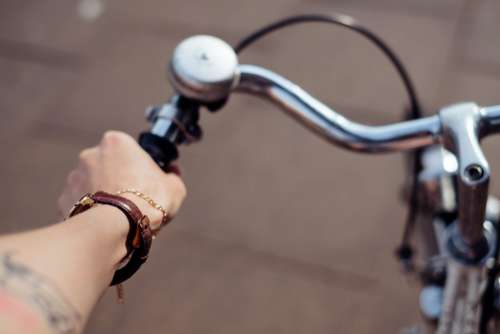 Female hand holding a bicycle handlebar