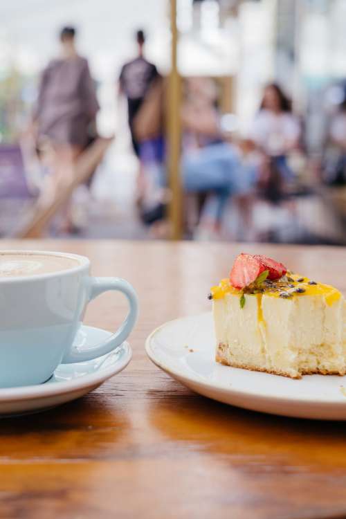 Latte and a cheesecake on a café table 4