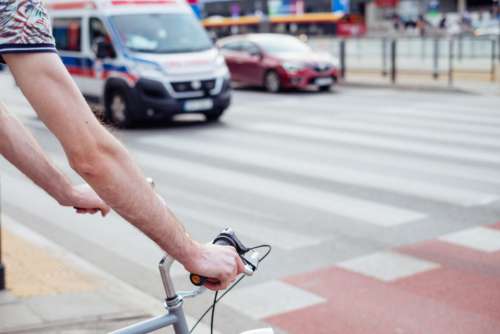 Male cyclist waiting for a green light at the road crossing