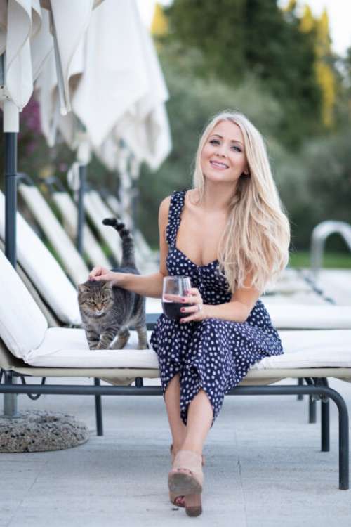 Woman Petting Cat Free Photo