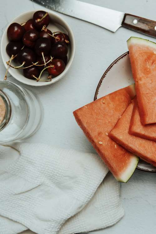 Sliced Watermelon And Ripe Cherries Photo