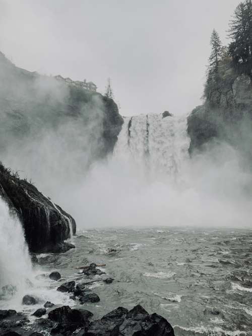 Waterfall Creating Mist Over The Shore Photo