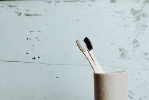 Two Wooden Toothbrushes In A Wooden Cup Photo