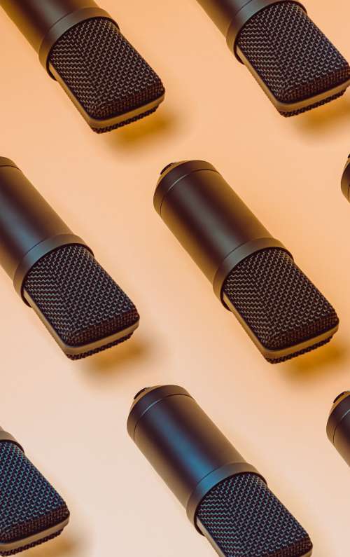 Black Microphones Pattern On A Yellow Background Photo