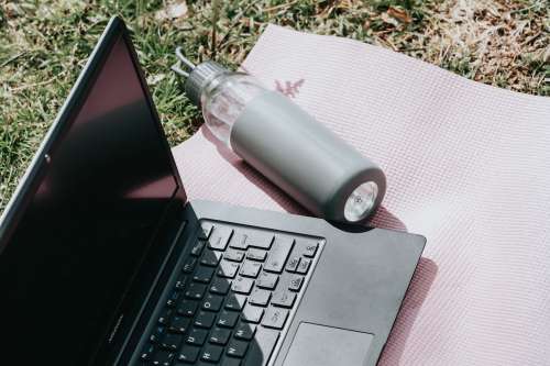 Outdoors Laptop And Water Bottle Lay On Pink Yoga Mat Photo