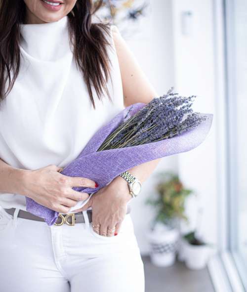 Person Holds A Bundle Of Lavender Wrapped In Purple Fabric Photo