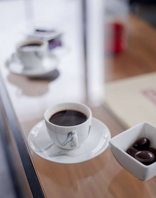 Black Coffee  Accompanied By Square Bowl Of Olives Photo