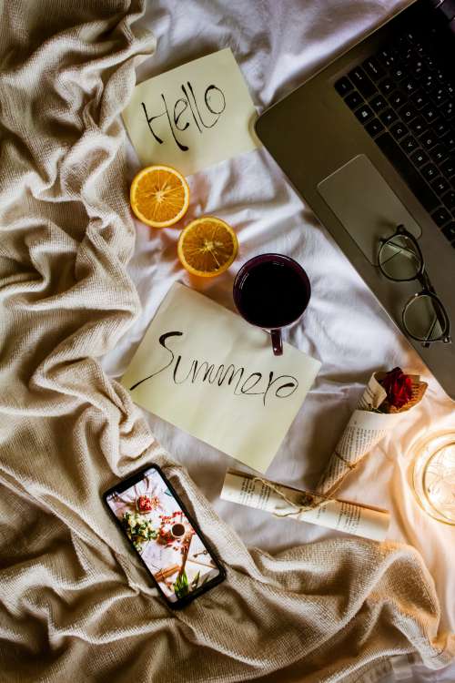 Flatlay Of A Cozy Bed With The Words Hello Summer Photo