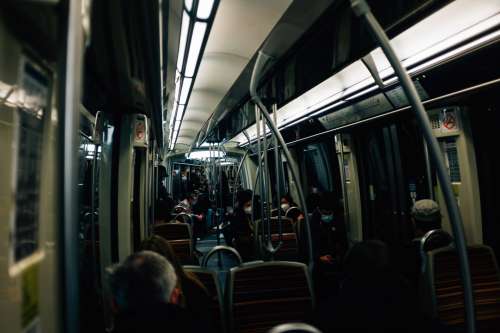 Interior Of A Dark Transit Vehicle With People Nearby Photo