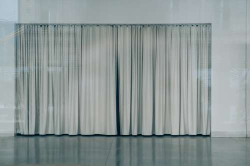 A Closed Grey Curtain Surrounded By A Grey Wall Photo