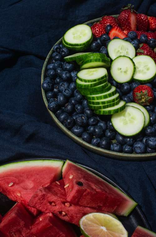 Two Plates On A Linen Tablecloth With Summer Fruit Photo