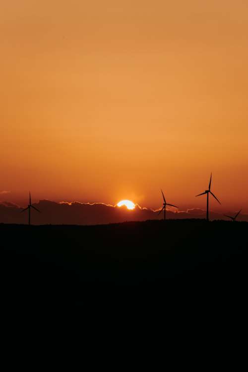 Sunset Behind Fluffy Cloud Silhouetting The Landscape Photo