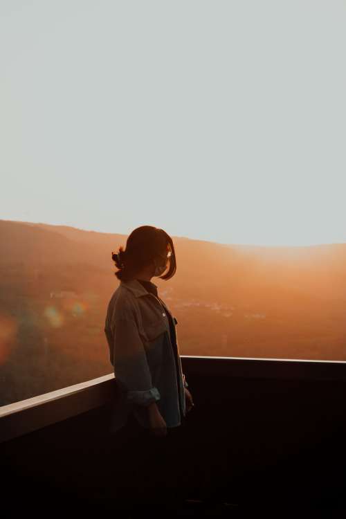 Person Silhouetted By Warm Light Of The Setting Sun Photo