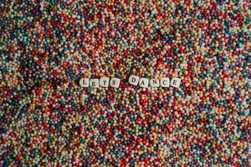 Flatlay Of Blocks Spelling Lets Dance On Colorful Dots Photo
