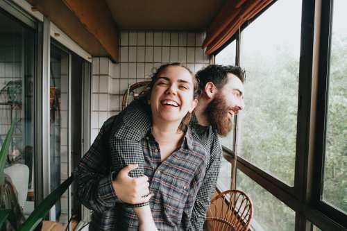 Man And Woman Smile Together Standing In A Solarium Photo