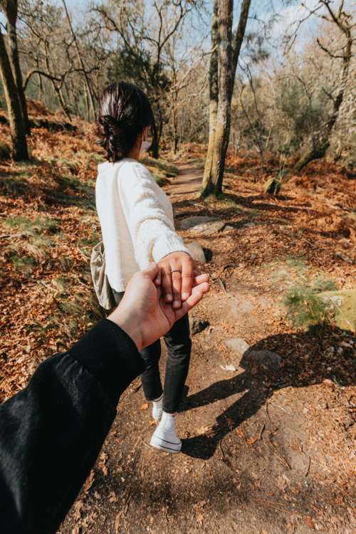 Person Leads Someone By The Hand Down A Hiking Trail Photo