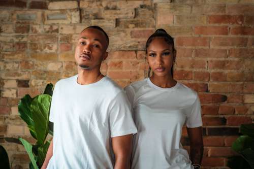 Two People In White T Shirts Pose For The Camera Photo