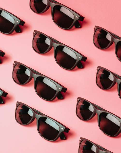 Lined Black Sunglasses On A Pink Surface Photo
