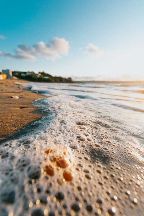 Close Up Of Lapping Waves On A Sandy Beach Photo