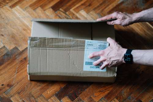 Top View Of Hands Ready To Open A Cardboard Box Photo