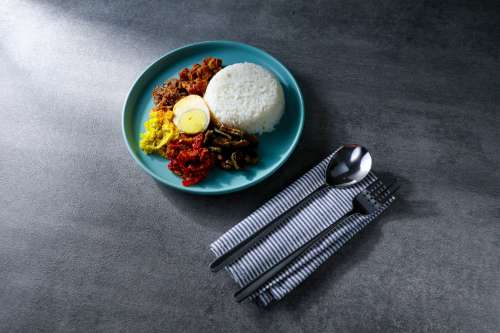 Minimal Blue Plate Of Food And A Place Setting Photo