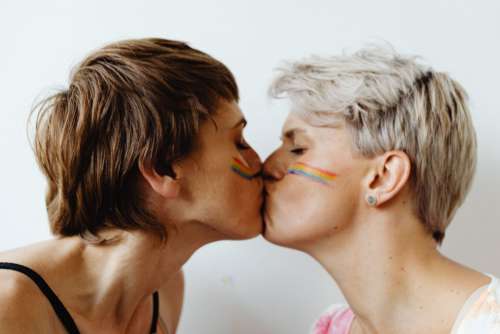 Girls paint an LGBT rainbow on their bodies