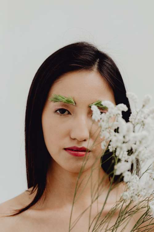 Sensual Portrait Of A Asian Woman With Flowers On Her Face