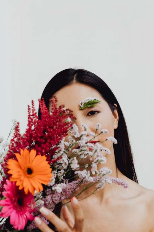 Sensual Portrait Of A Asian Woman With Flowers On Her Face