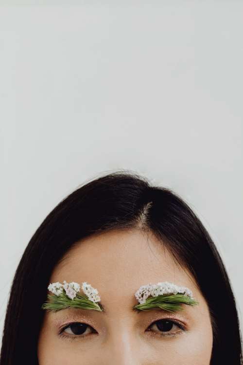 Sensual Portrait Of A Asian Woman With Flowers On Her Face