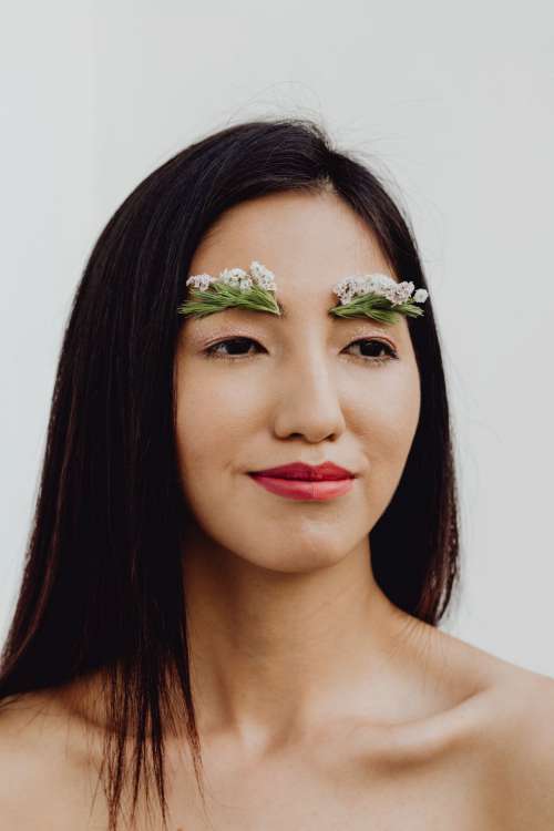 Sensual Portrait Of A Asian Woman With Flowers On Her Face