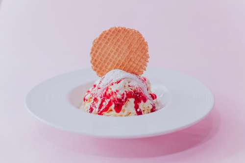 A Red And White Dessert And Cookie On White Plate Photo