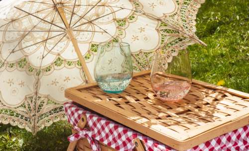 Cloth Parasol Lays On The Grass Next To A Picnic Basket Photo