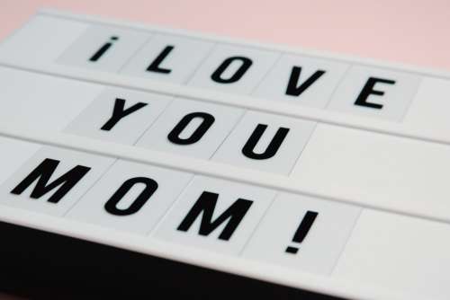 White Sign With Black Text Saying I Love You Mom Photo