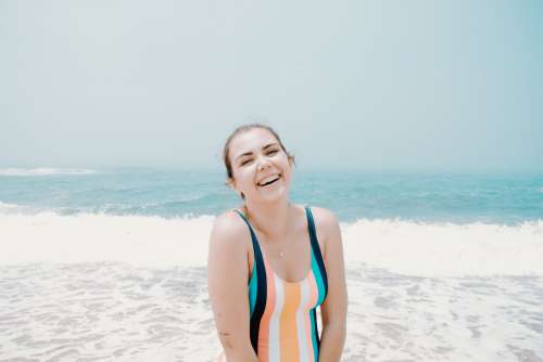 Woman Laughing By Aqua Blue Ocean Water Photo