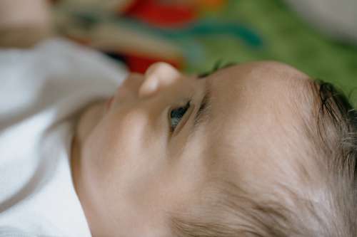 Close Up Of A Babys Face In Profile On Colorful Mat Photo