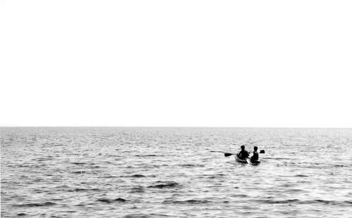 Monochrome Image Of A Small Boat On Open Water Photo