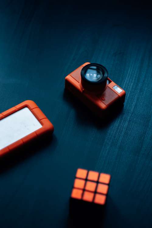 Orange Rubiks Cube Camera And Hard Drive Photo